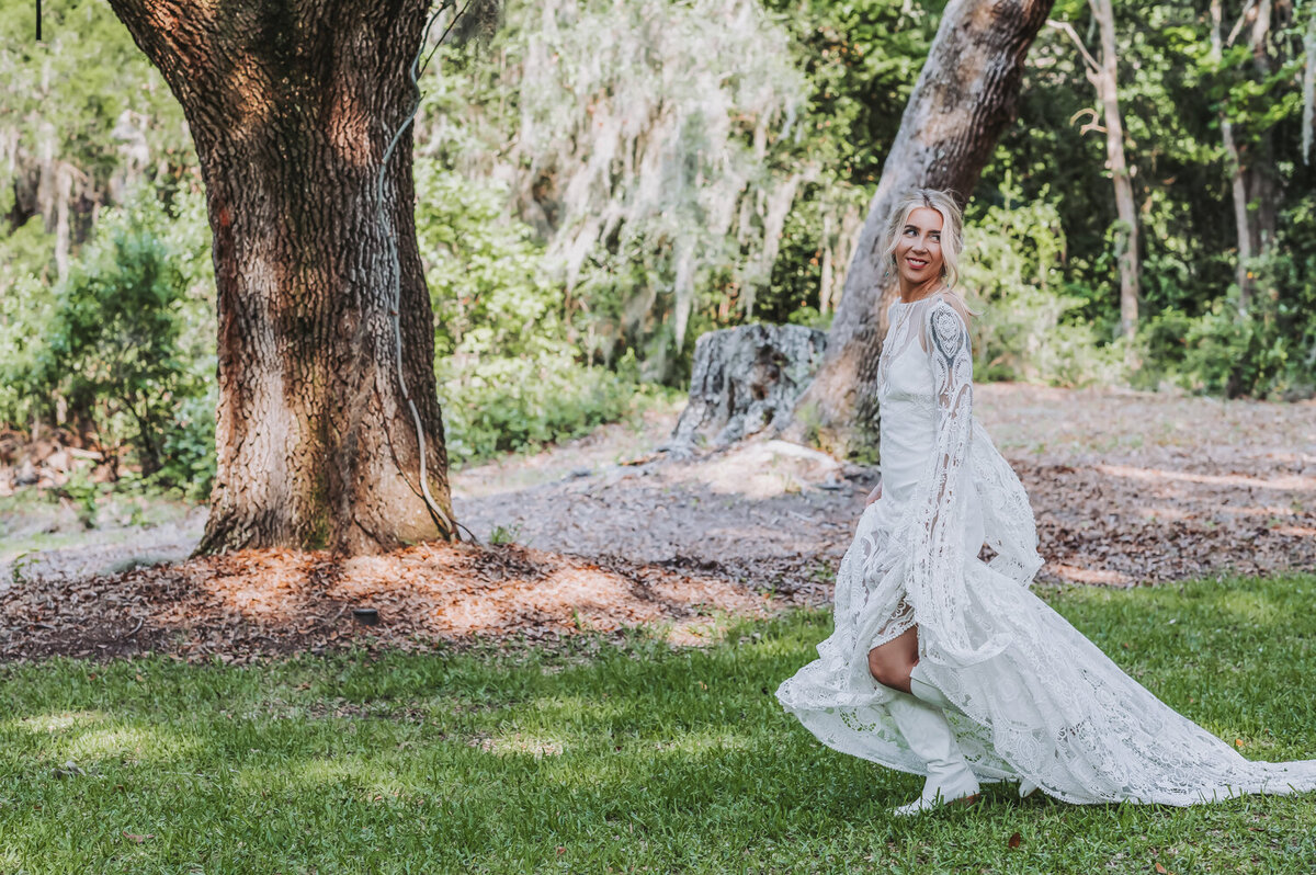 Boho bride running under spanish moss