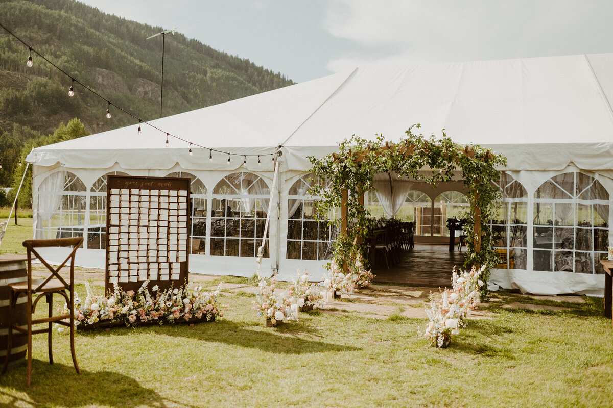 A white wedding tent in a grassy field