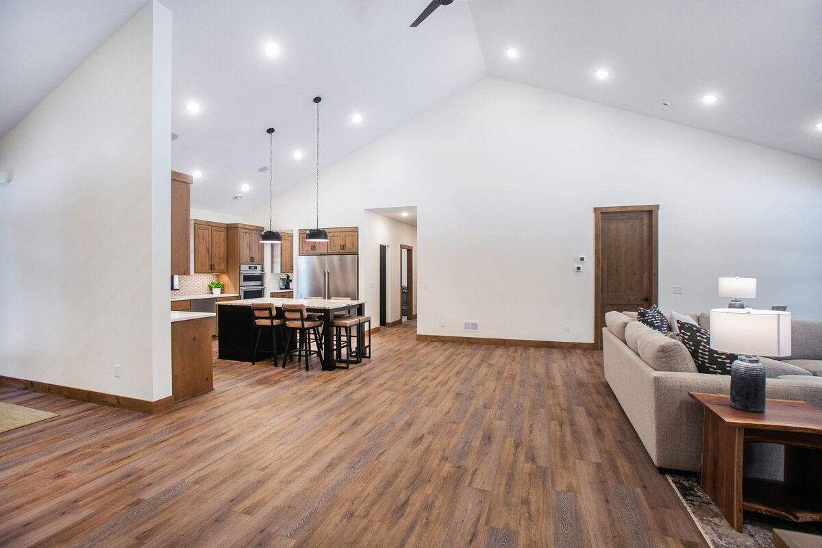 Cozy living room in Elk River custom home with fireplace, built-ins, and large windows
