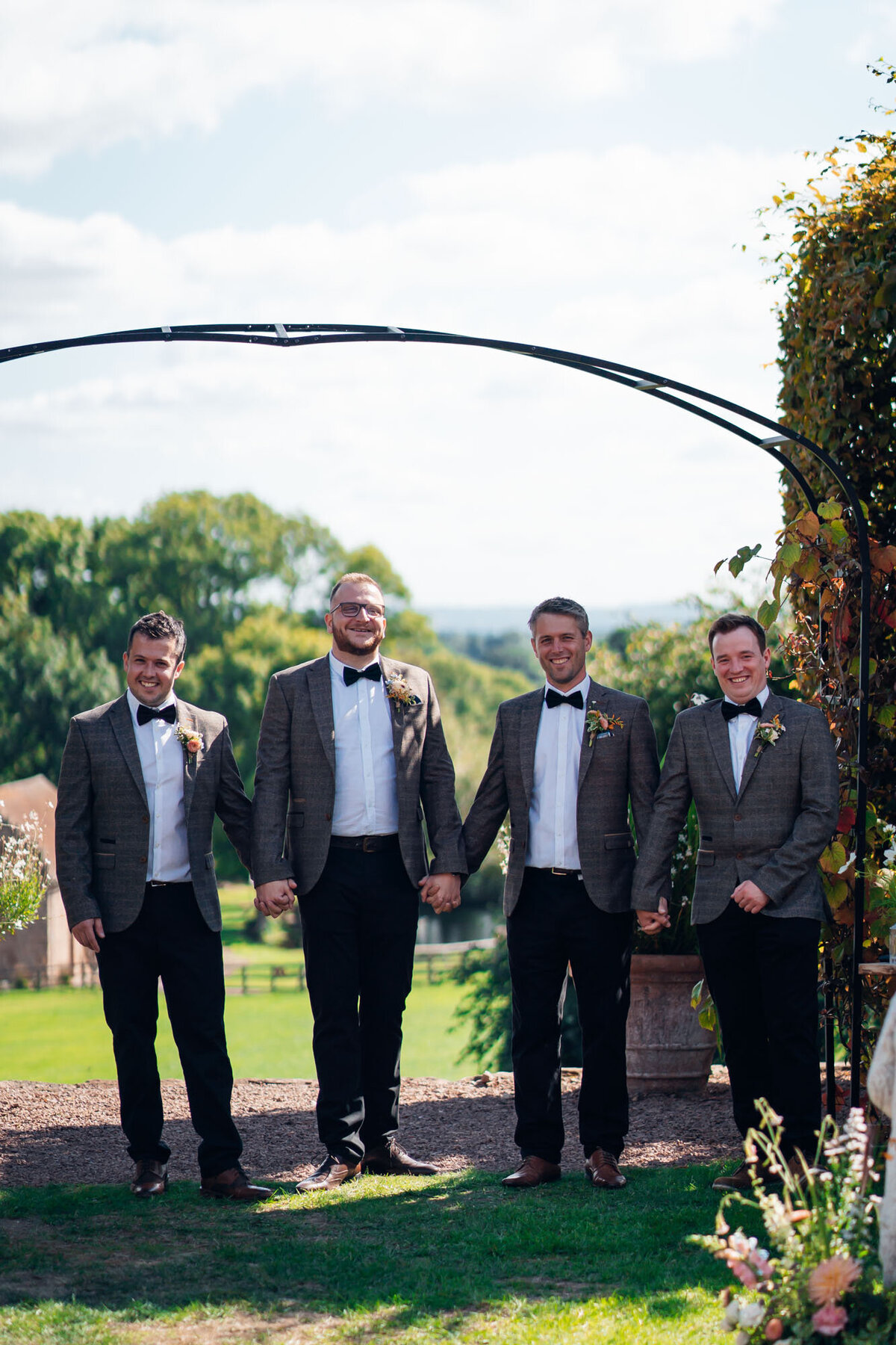 Pauntley-court-wedding-photographer-groomsmen-during-outdoor-ceremony