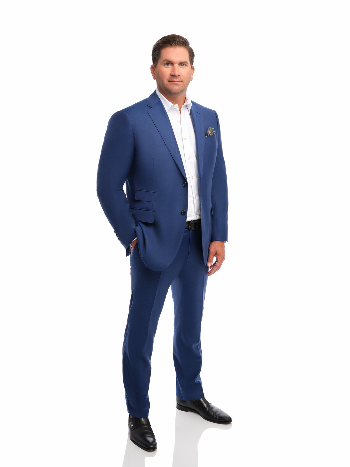 A man in a suit with one hand in his pocket