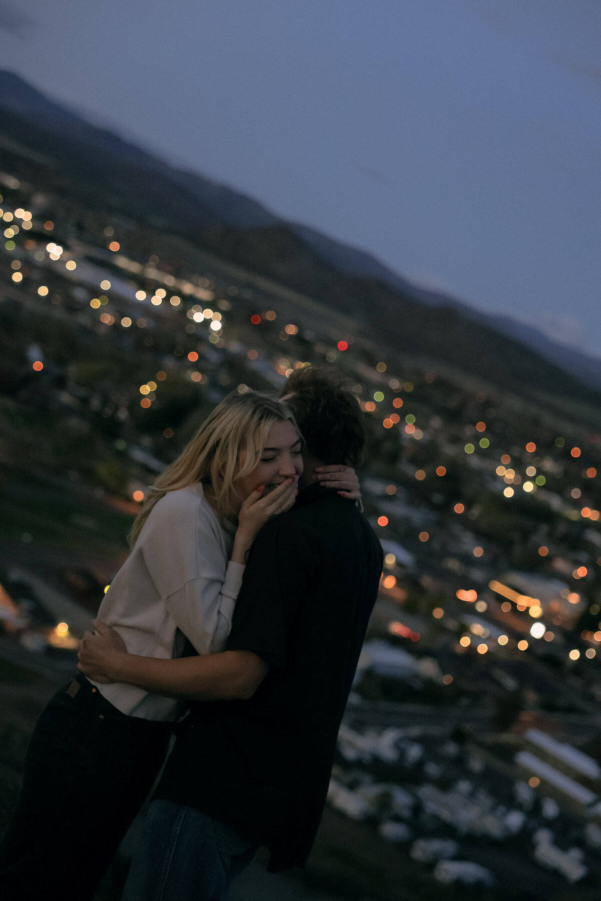 Emotional Engagement Session Overlooking City Lights at Blue Hour
