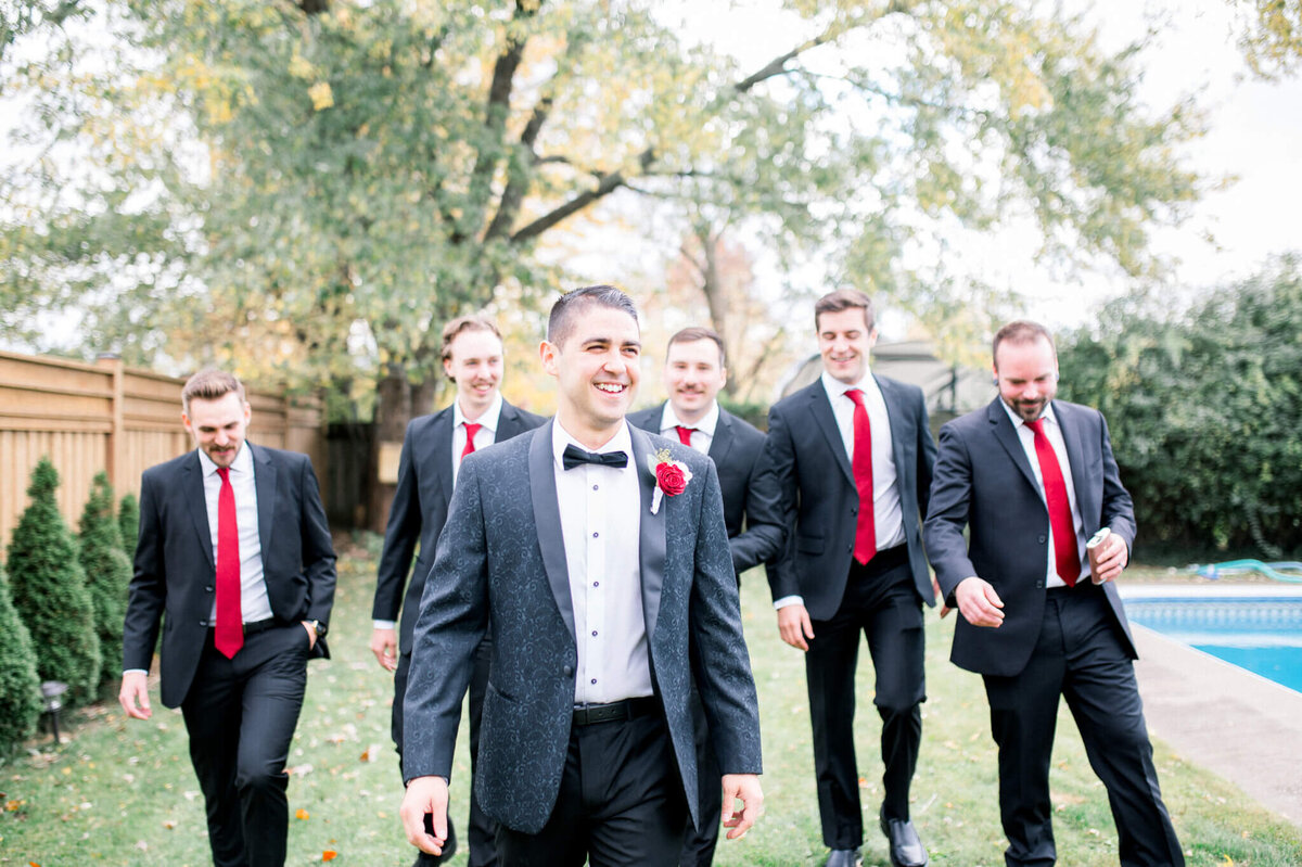 Niagara wedding photography of groom and groomsmen walking toward camera