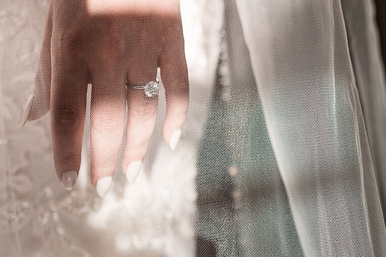Detail image of diamond ring under vail in Wentworth Inn wedding in Jackson NH by Lisa Smith Photography