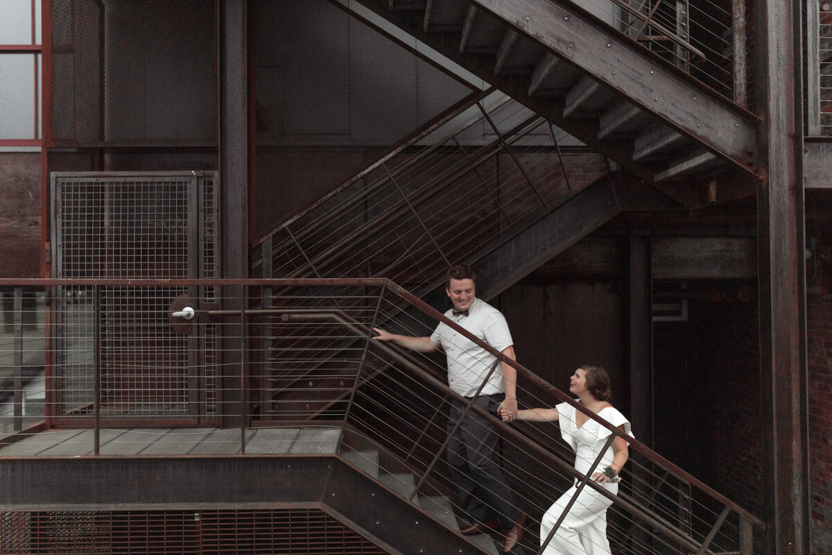 bride and groom climbing stairs