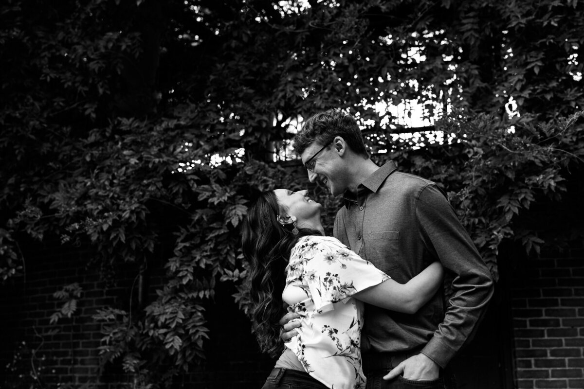 Couple snuggles and laughs during engagement session