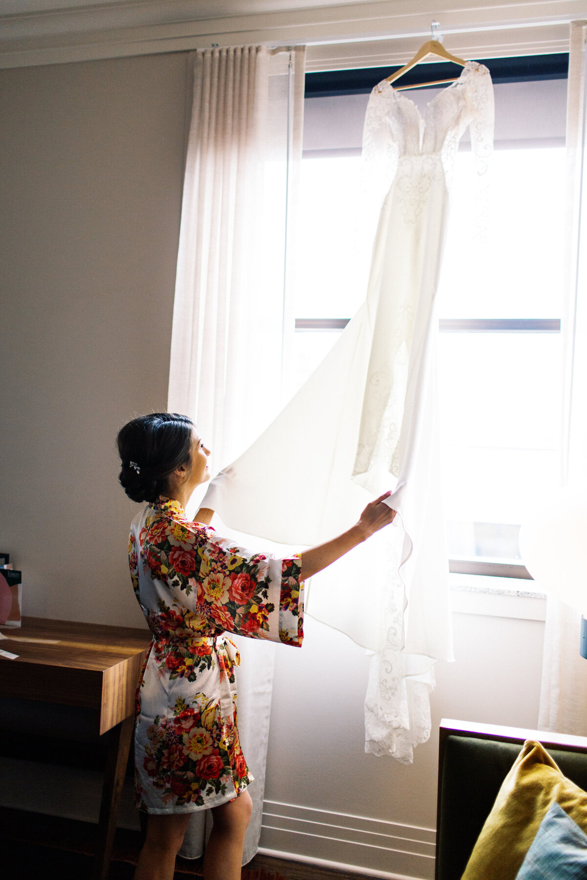 bride looking at her dress in Minneapolis hotel