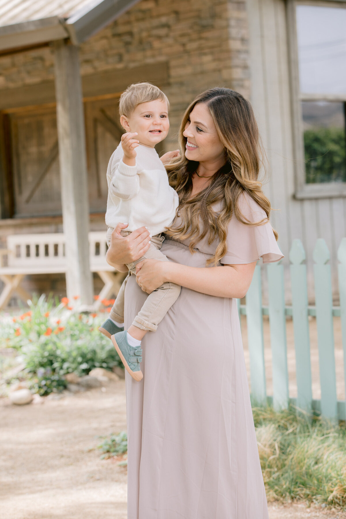 A mom smiling and holding her child