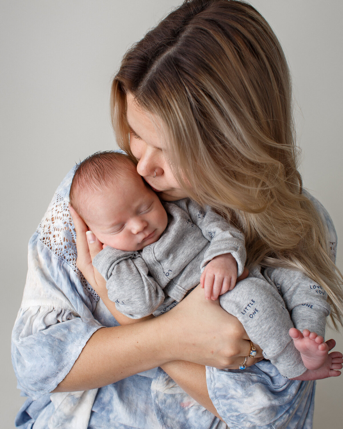 Portrait of a new mom with her infant baby