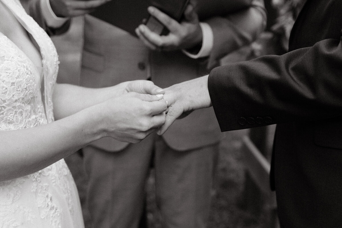Outdoor ceremony with candid vow exchange and connection.