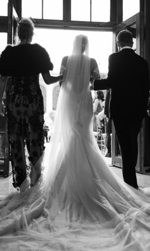 Bride walking down the aisle with her parents at The Breakers in Palm Beach, captured by Claudia Amalia Photography.