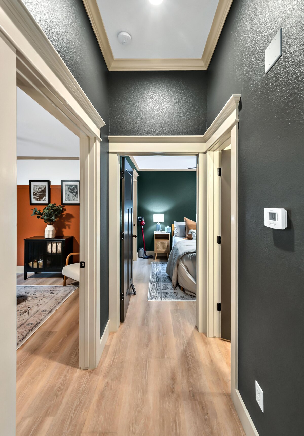 Hallway opening up to bedrooms in this three-bedroom, three-bathroom vacation rental home with free wifi, outdoor theater, hot tub, propane grill and private yard in Waco, TX.