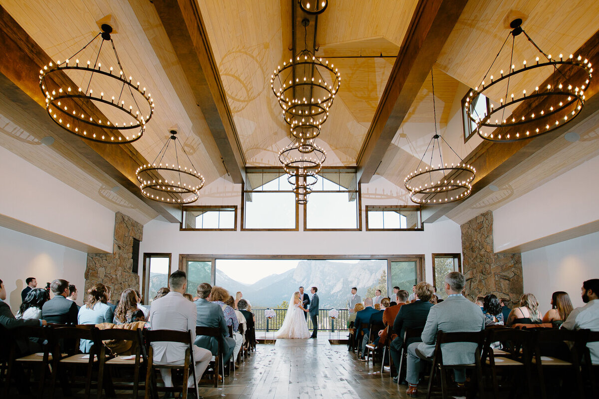 A bride and groom hold hands at the altar during their wedding ceremony at Black Canyon Inn.