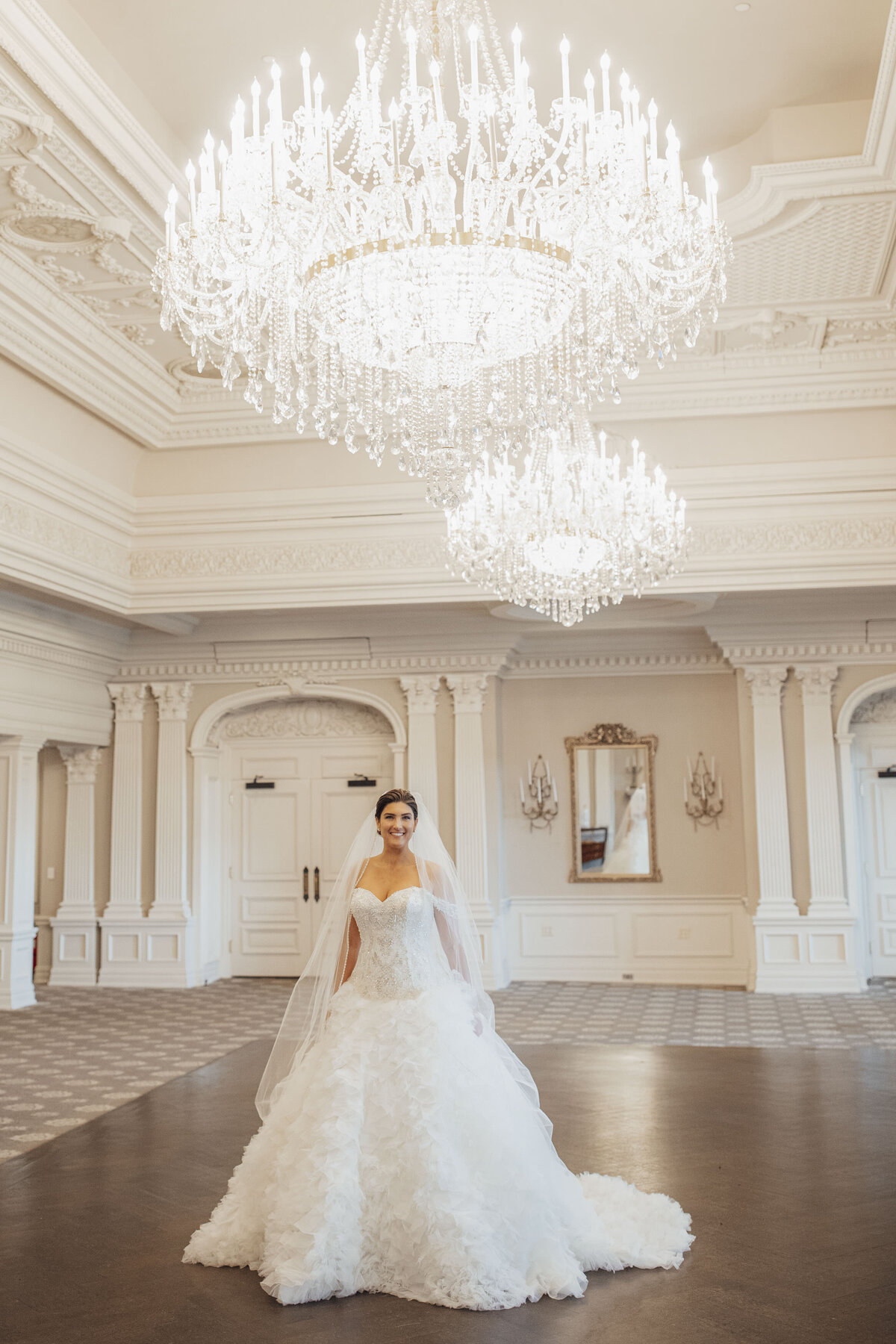 park-savoy-bride-posing-in-ballroom-with-chandeliers-florham-park-new-jersey