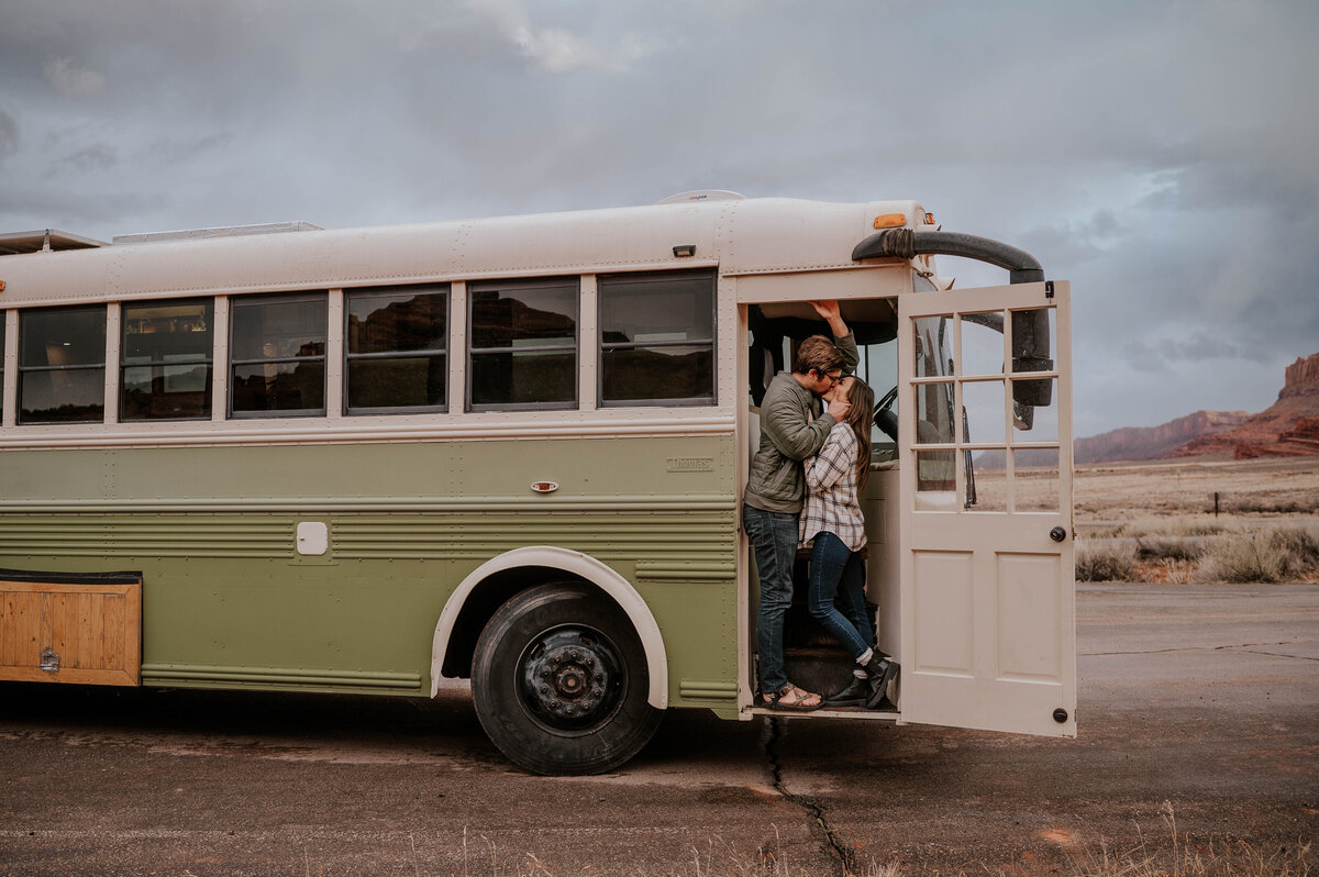 Engaged Couple kissing on bus parked on Alberta farm land