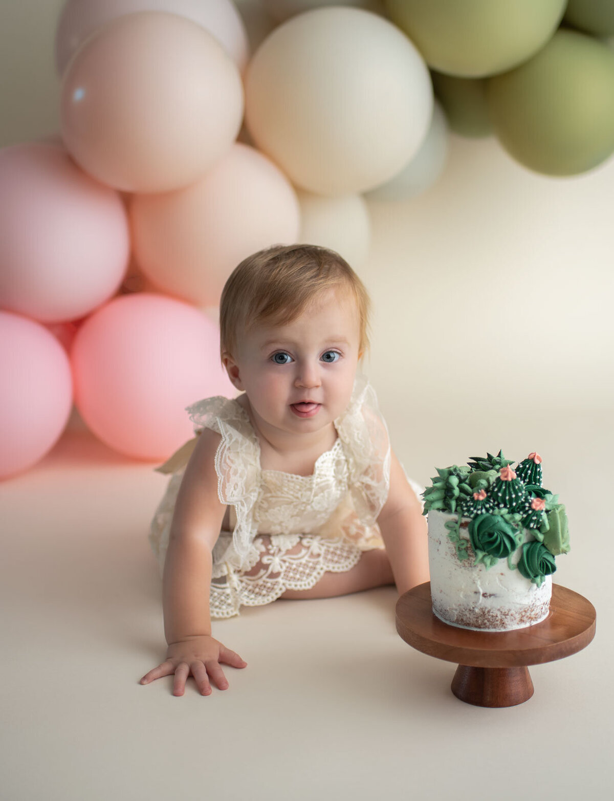 baby sticking her tongue out at st. louis cake smash photoshoot