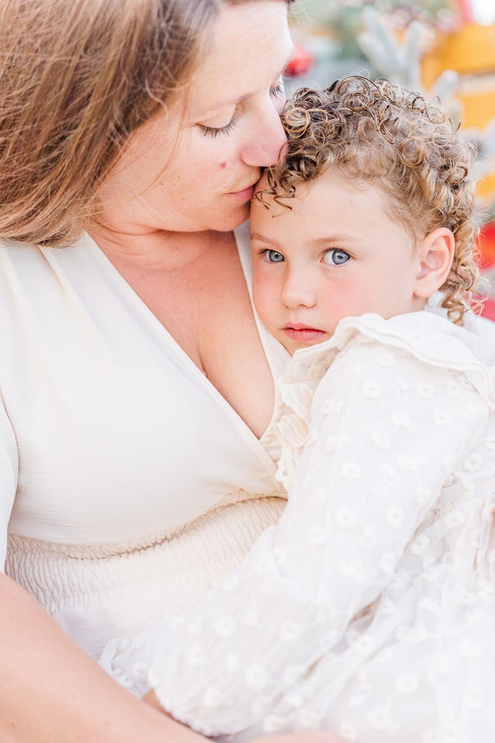 mom kissing daughter during their Haymarket, VA family photography