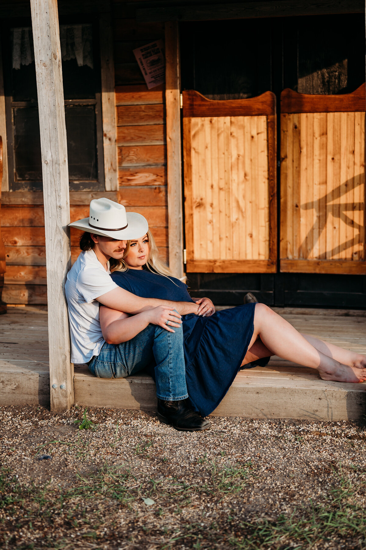 engaged couple cuddle up to watch the sunset in Edmonton, Alberta