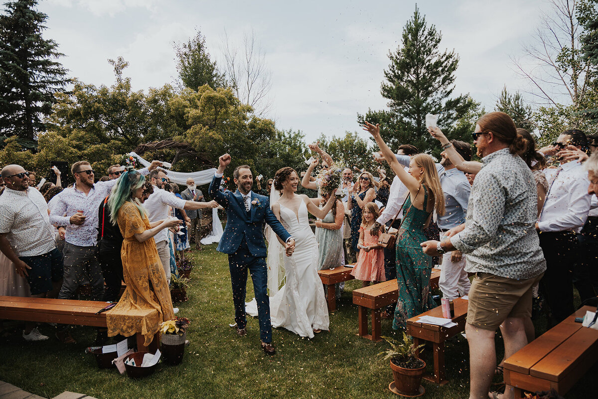 A couple walks down the aisle after saying I do