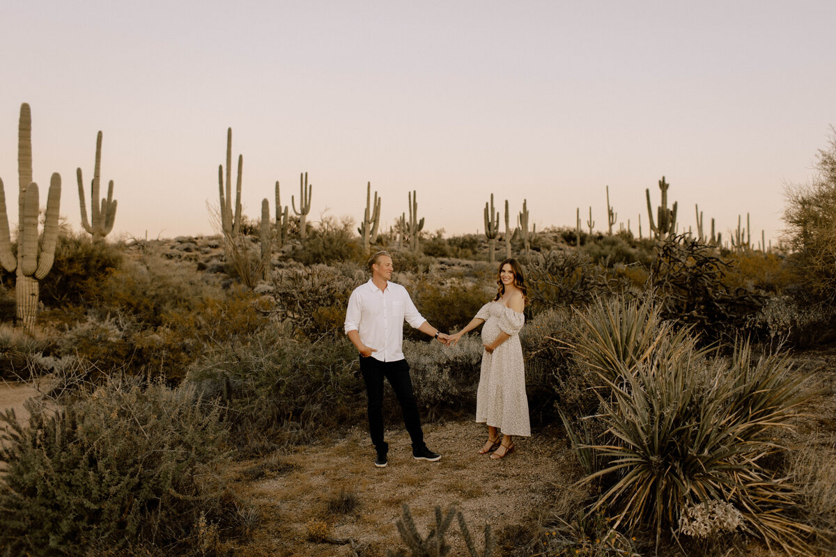 couple holding hands in arizona desert
