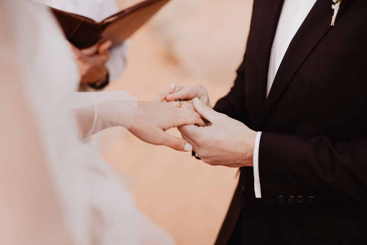 Utah elopement photographer captures groom putting ring on bride