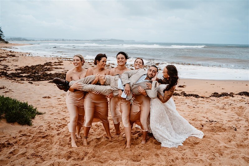 "Tamara and Matthew, surrounded by their joyful bridal party, capture unforgettable moments during their fun-filled photoshoot. Join in as love, laughter, and cherished memories unfold in this delightful celebration of marriage."