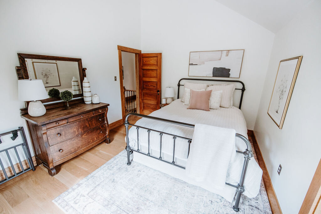 vintage bedroom dresser in the rose bedroom with Pottery Barn bedding in the modern farmhouse overnight accommodations at Willowbrook wedding venue