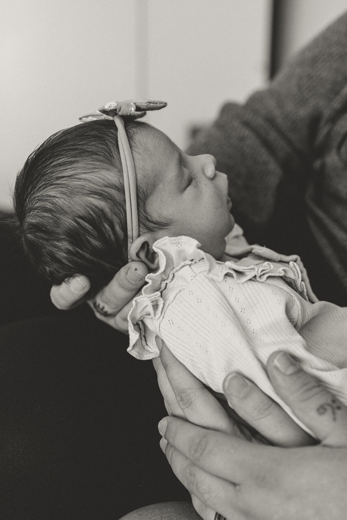 Side profile of Longmont Colorado newborn with bow in hair