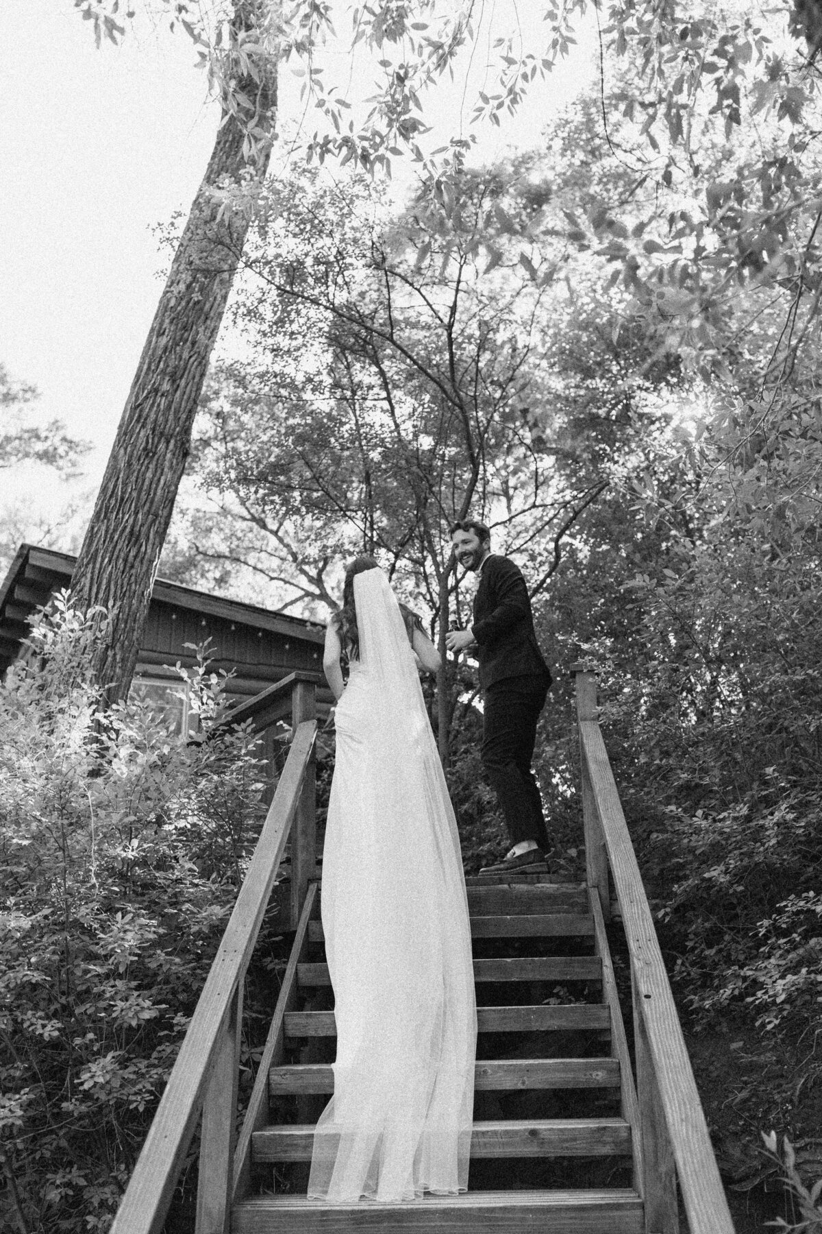 Bride and groom walking up stairs at Dallenbach Ranch Colorado Wedding