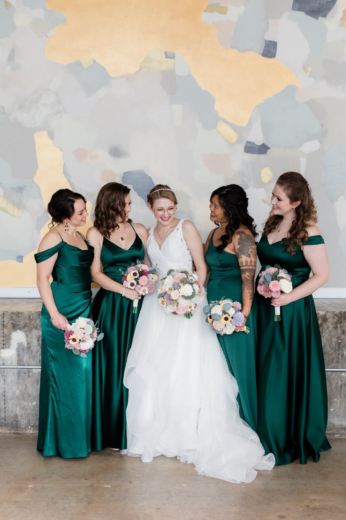 Bride and Bridesmaids wearing emerald green by the mural inside The Bond in York PA