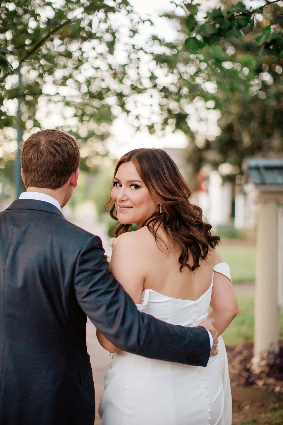 bride looking back at camera while walking