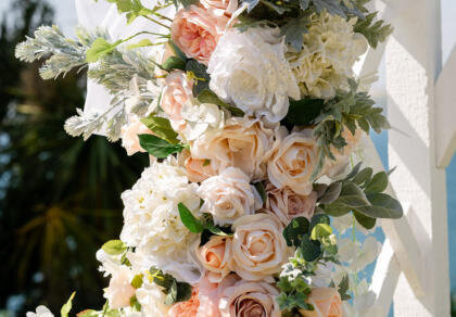 A bouquet of white and peach flowers on a pole