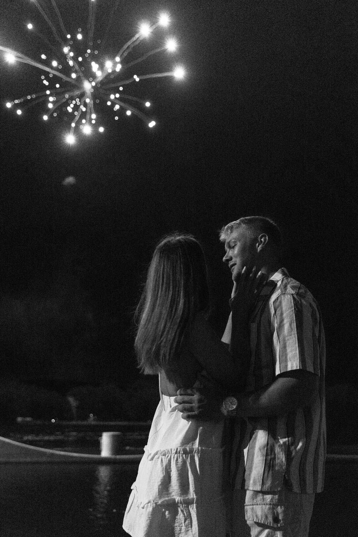 Black and White photo of couple watching fireworks on the 4th of july in Florida 