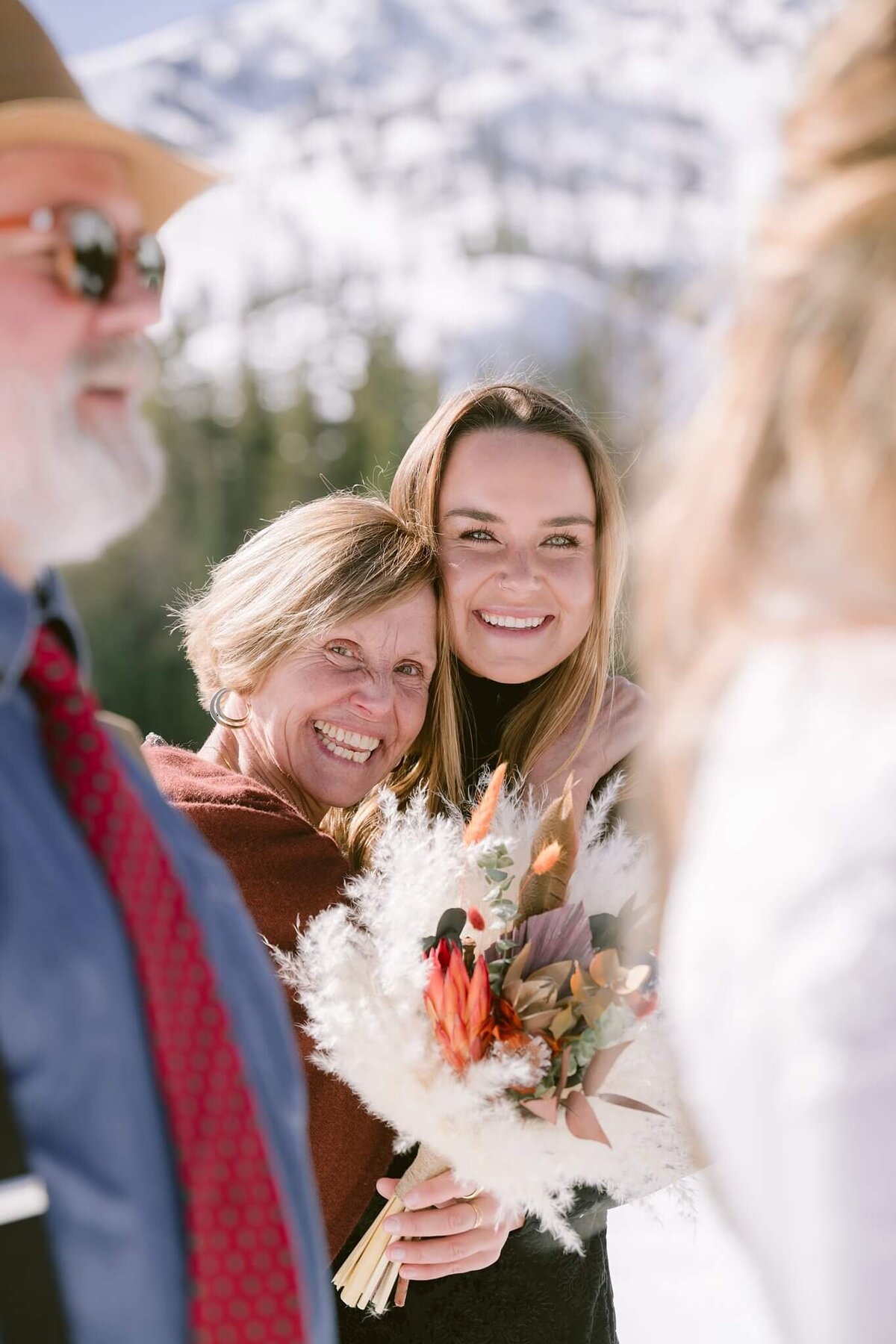 bride's mom and sister's reactions during ceremony of winter elopement with family in Alpine meadows Tahoe