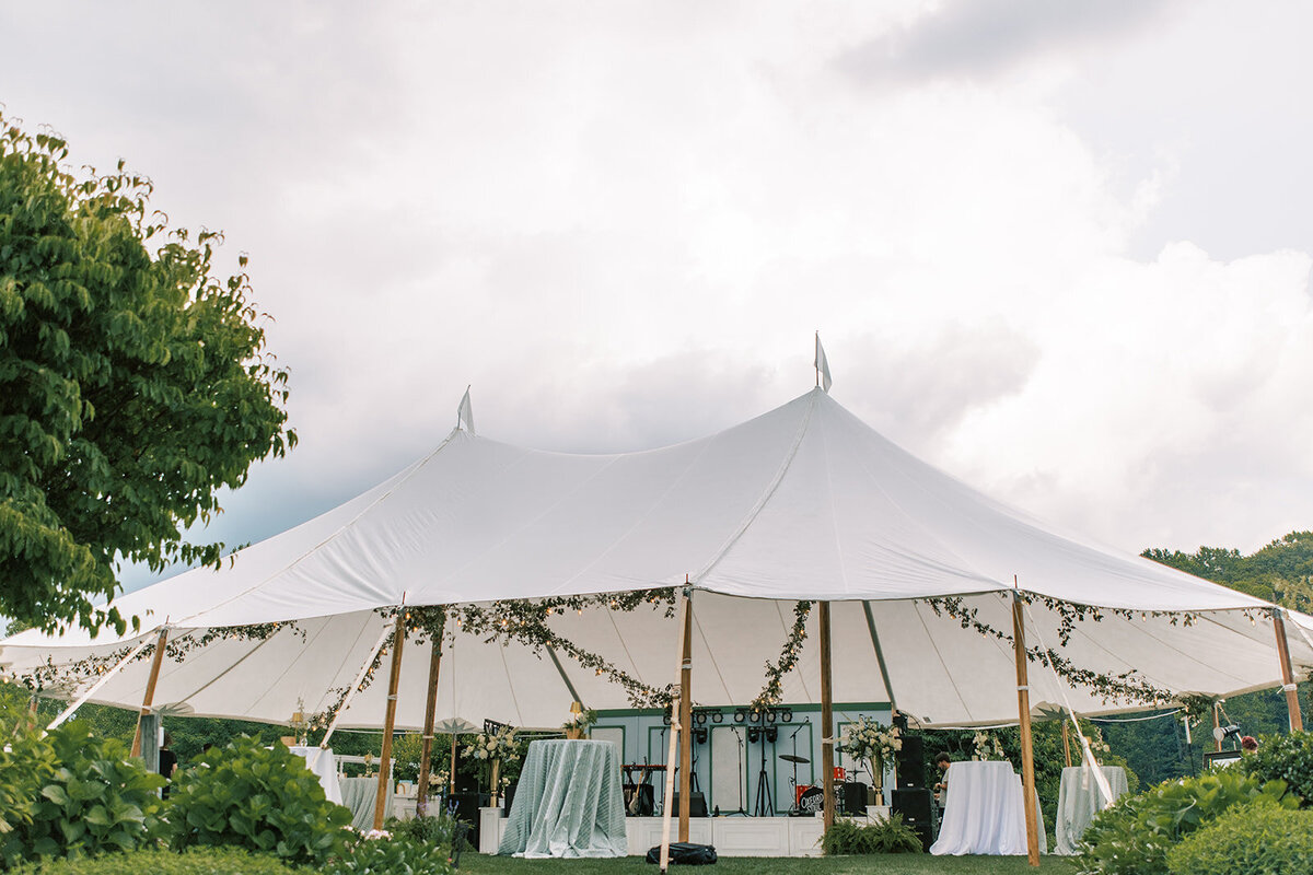 Sailcloth reception tent with floral greenery at a mountain wedding in Cashiers North Carolina.