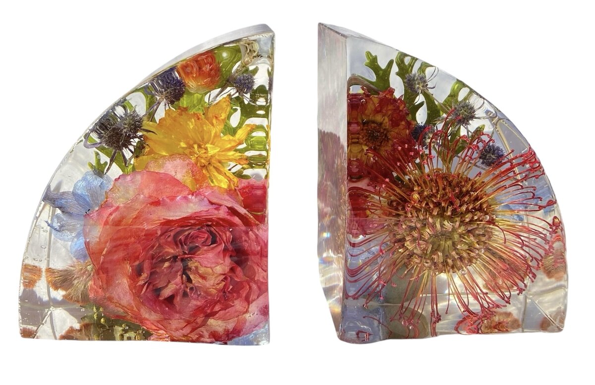 bookend resin block with bright pinks blues oranges and yellow wedding flowers preserved as a family heirloom