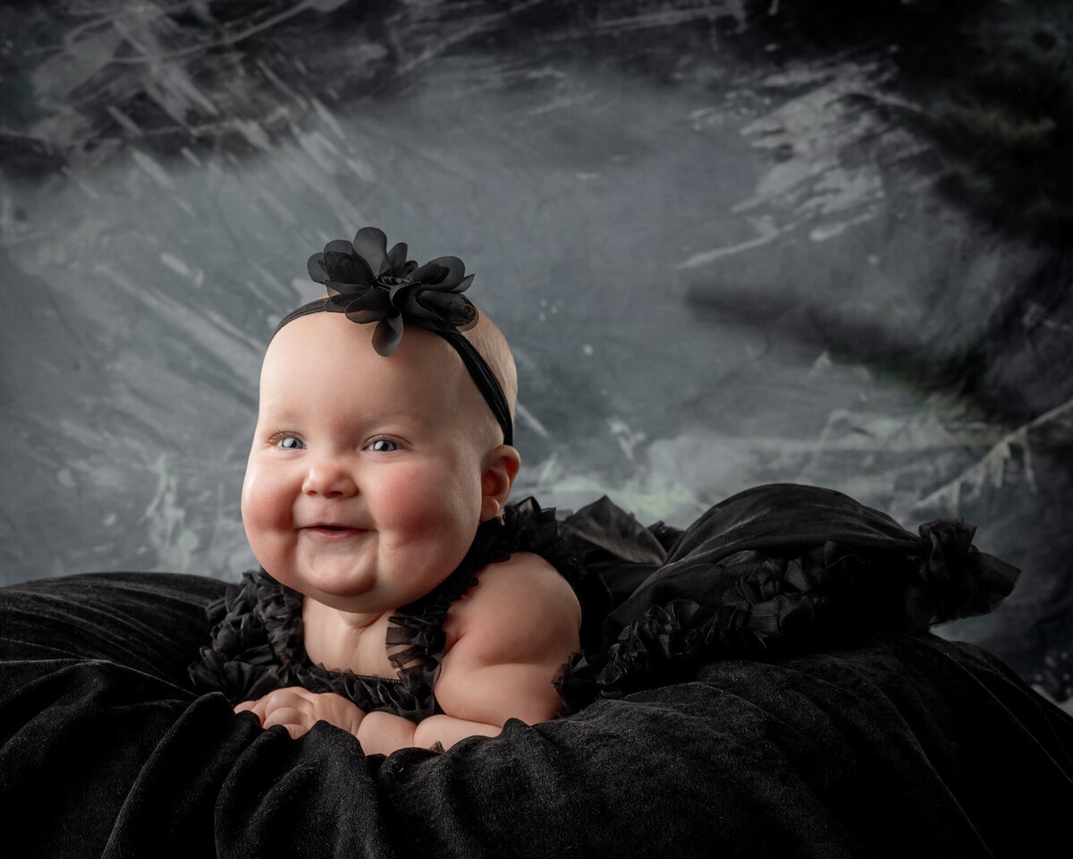 Young girl smiles and looks at her Iowa Family Photographer