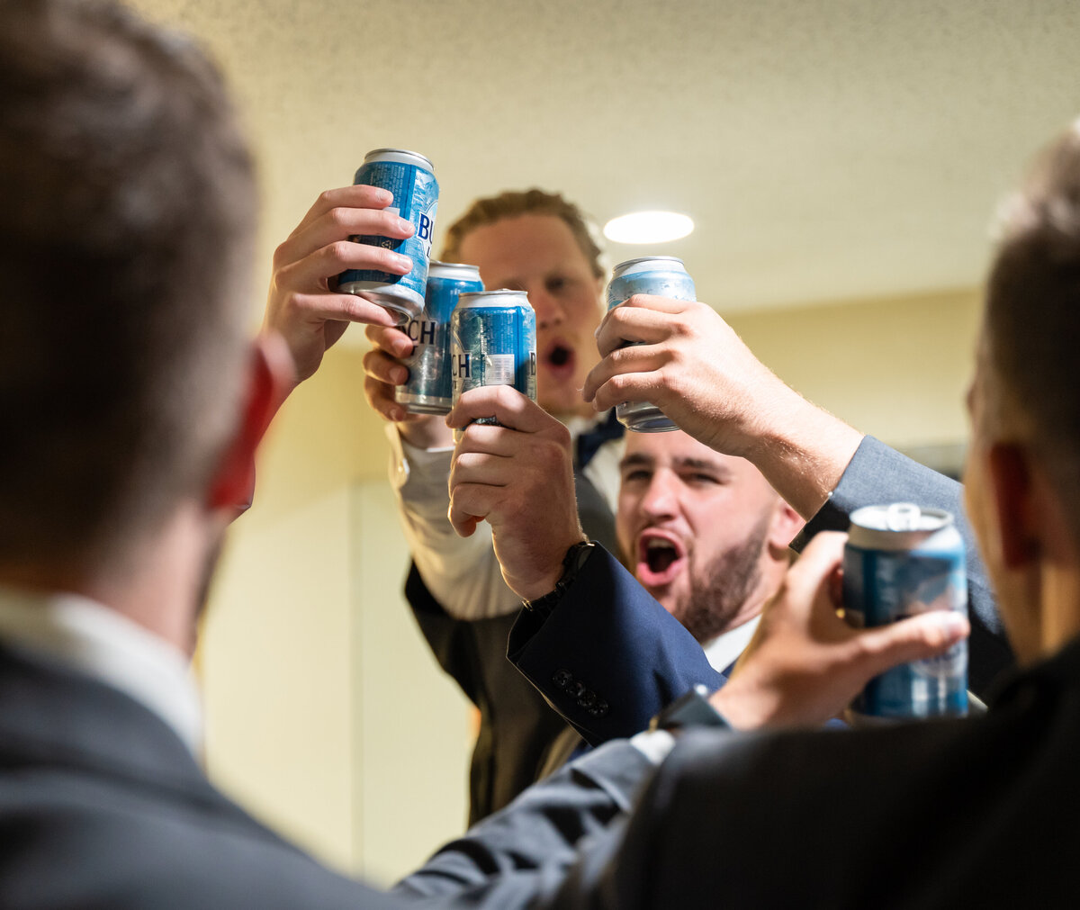 The groom, Ryan Bee, and his groomsmen cheers with Busch Light at their hotel in Canal Winchester, Ohio, in celebration of Ryan's wedding day.
