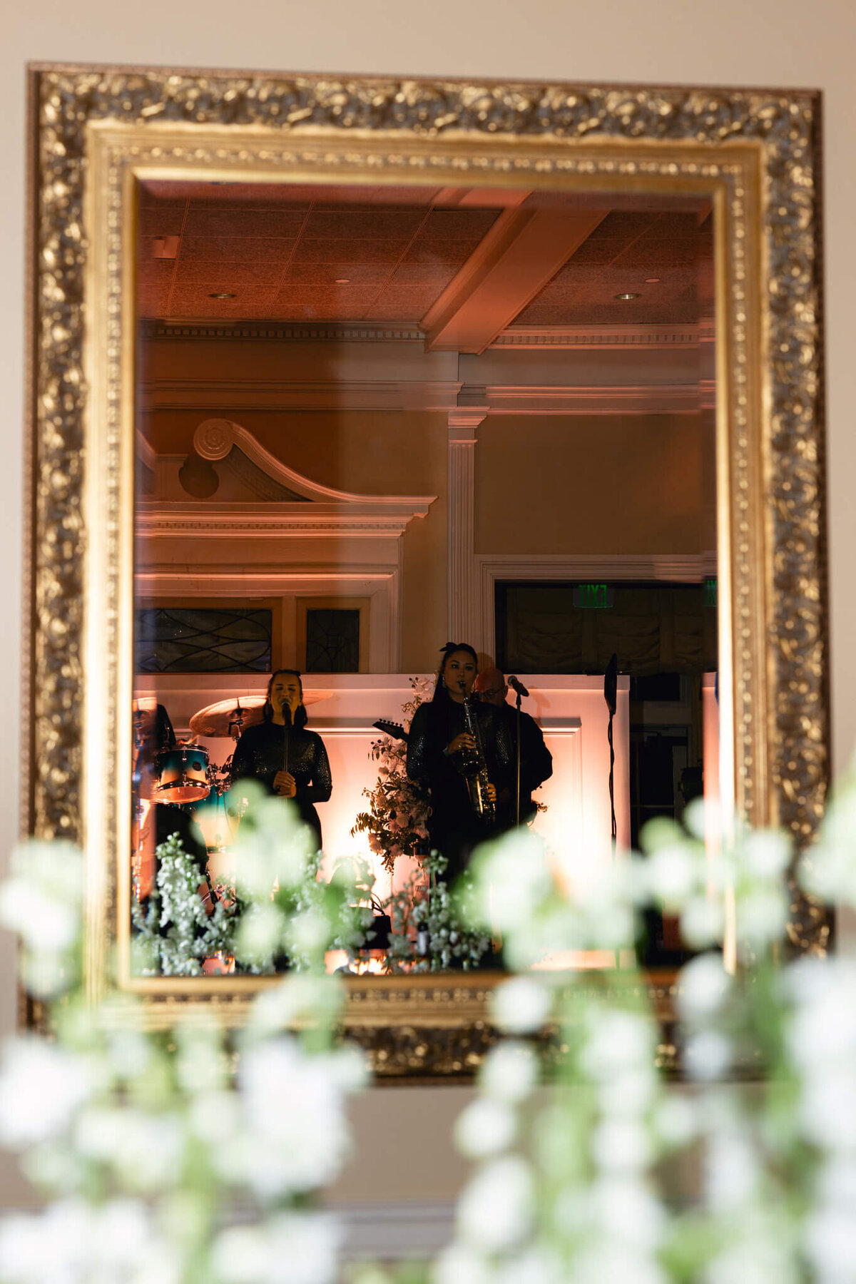 A picture of the band playing during the recpetion taken by shooting at a mirror