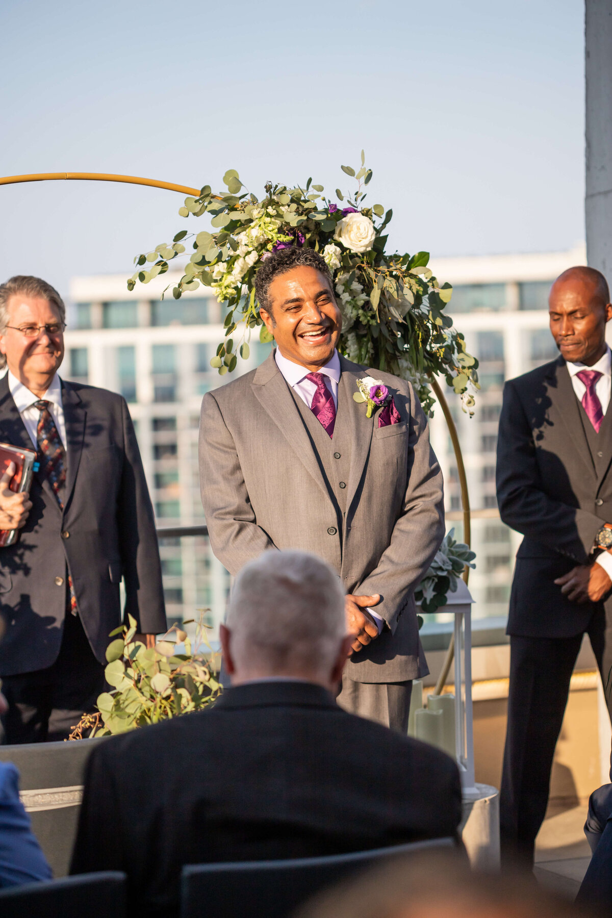 Bride smiling as he looks at bride walking down the aisle at The Aertson hotel, Nashville