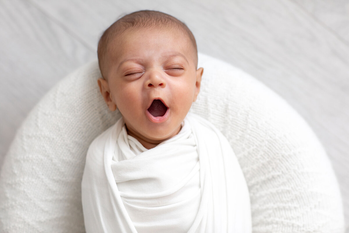a swaddled yawning newborn by Bucks County Newborn Photographer Ivory Tree Portraits