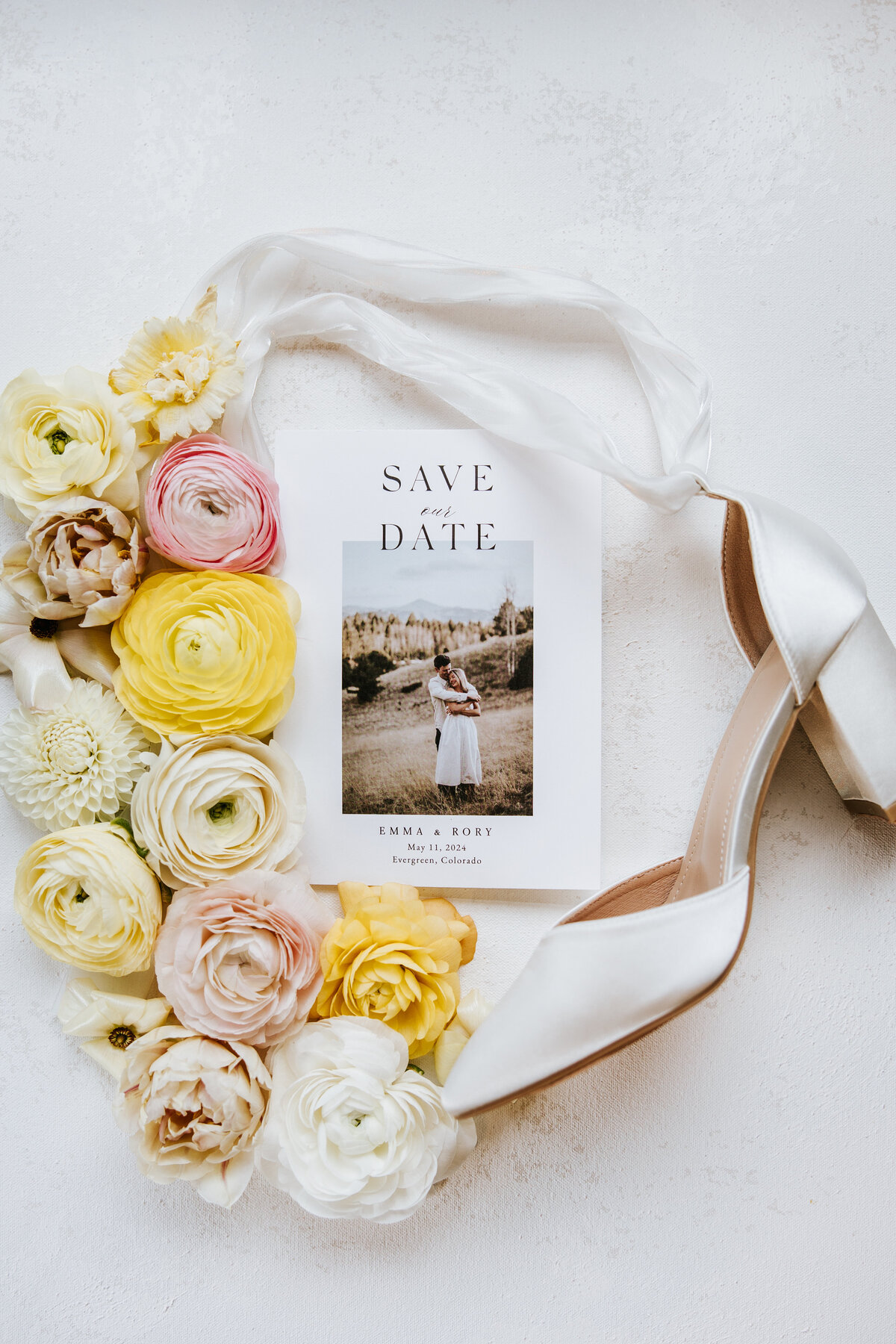 Flat lay of the bride’s shoes and wedding invitation, beautifully arranged with elegant details.