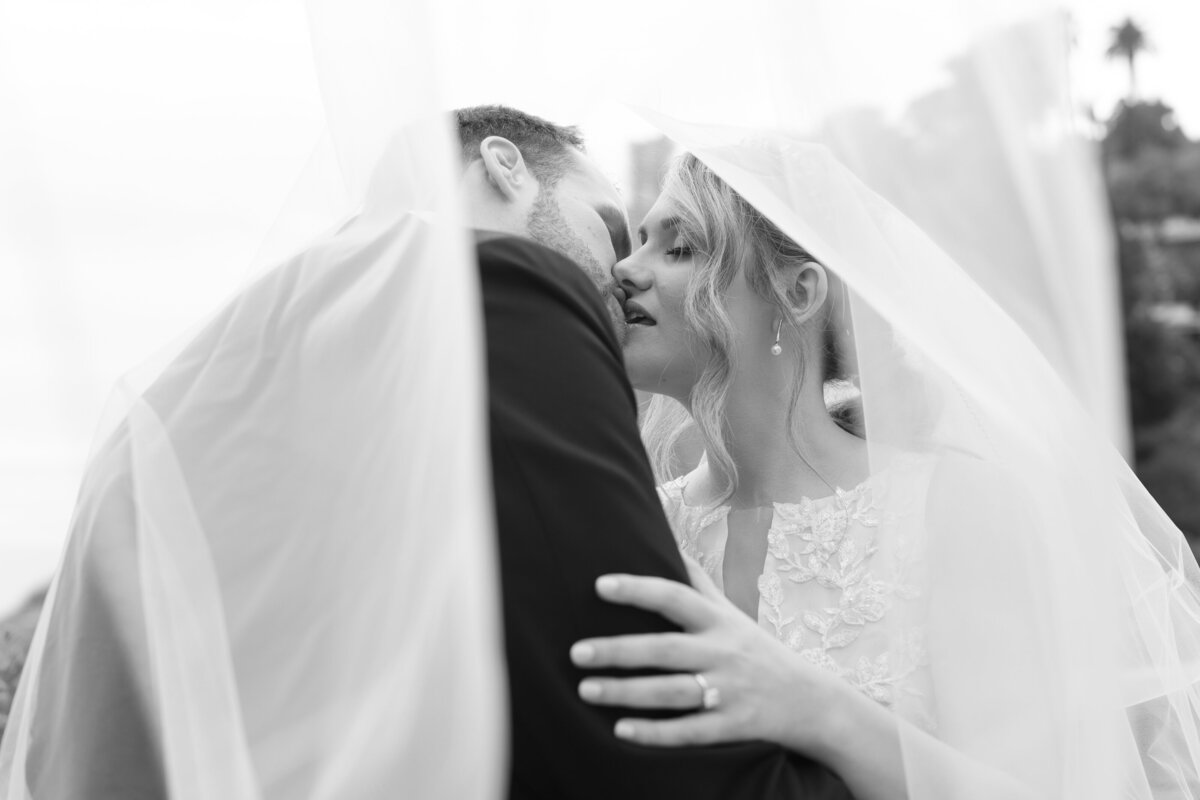 black and white photos of a bride kissing his groom