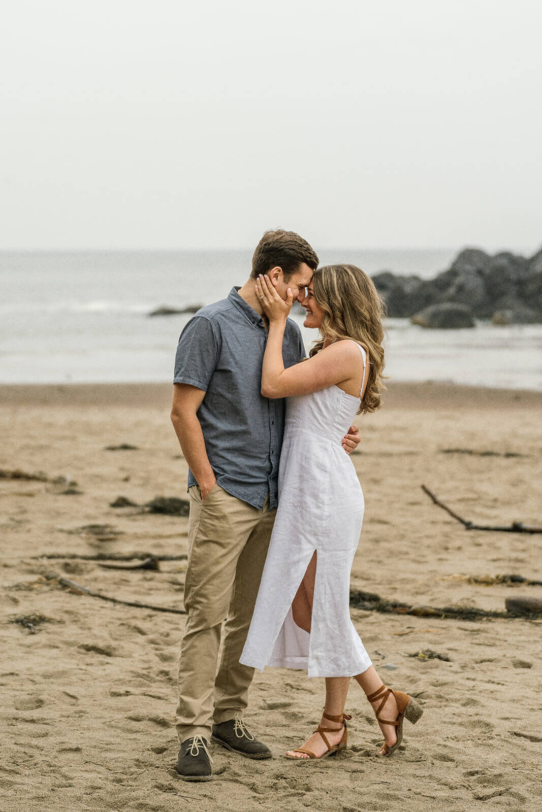 A couple kissing on the Oregon coast in Lincoln City. 