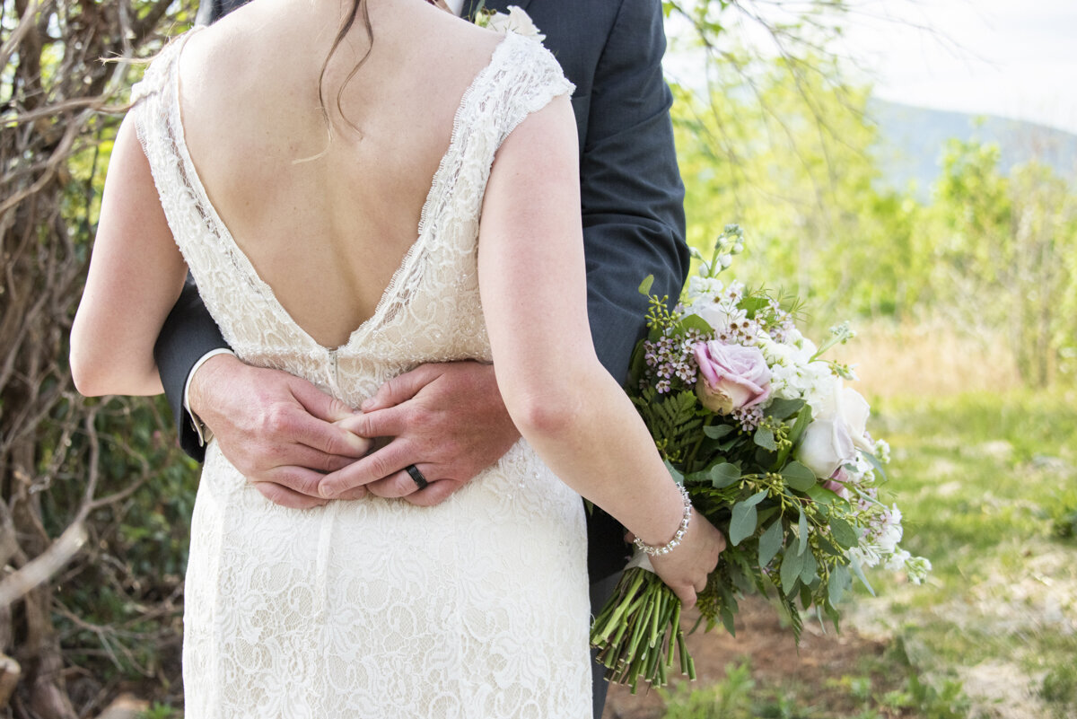 Groom holding onto bride
