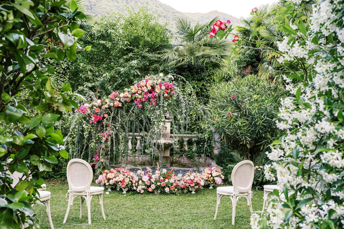 Lake Como Italy wedding ceremony tucked away in an enclosed garden surrounded by jasmine and flowers photographed by Lake Como Wedding photographer