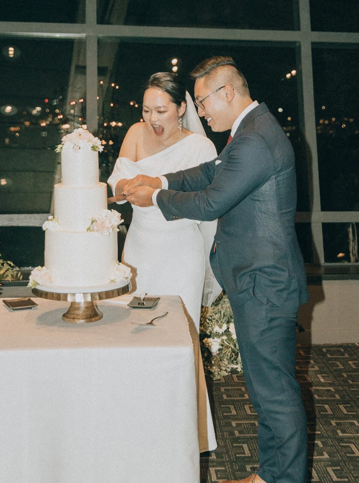 Couple cutting cake at their wedding reception