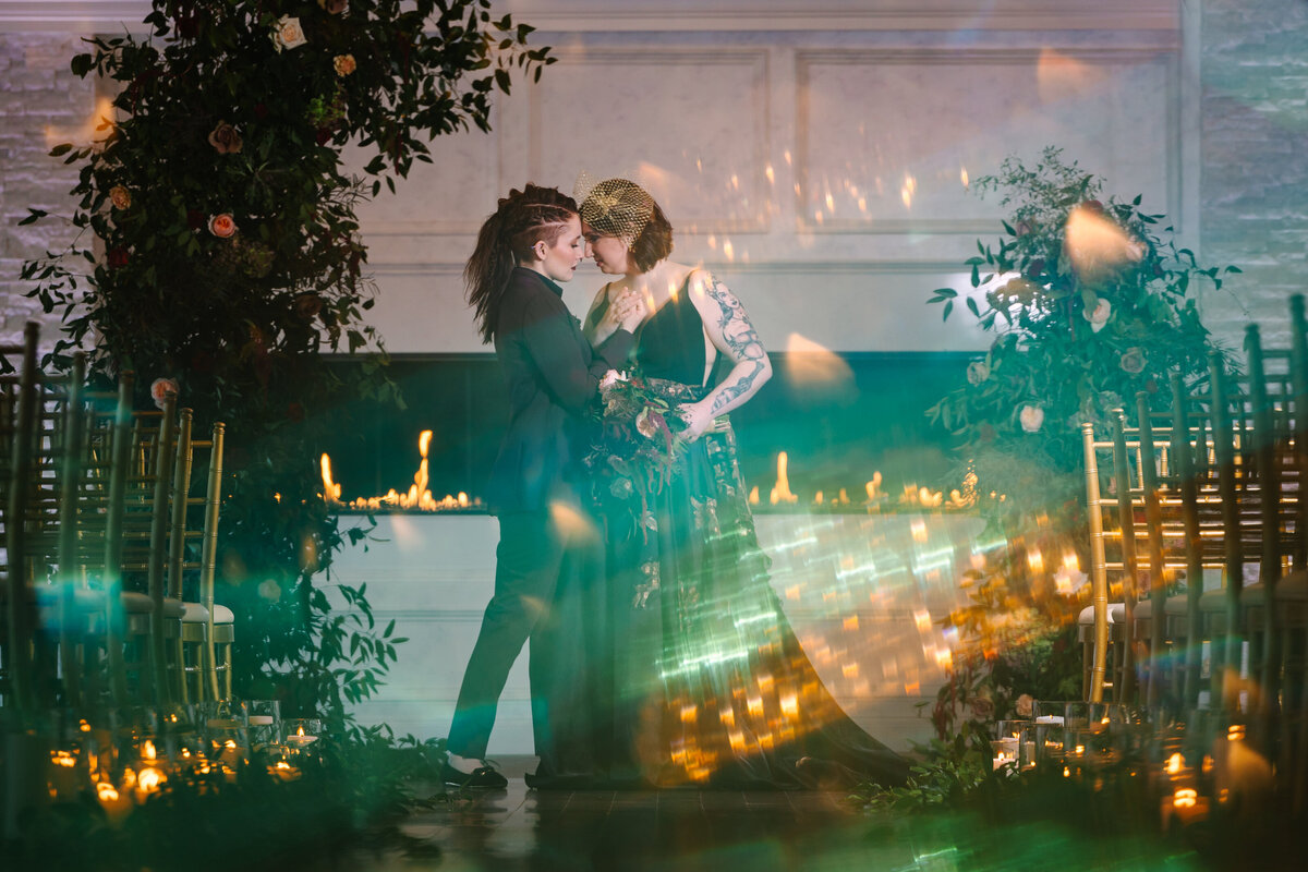 Brides kissing with light flare