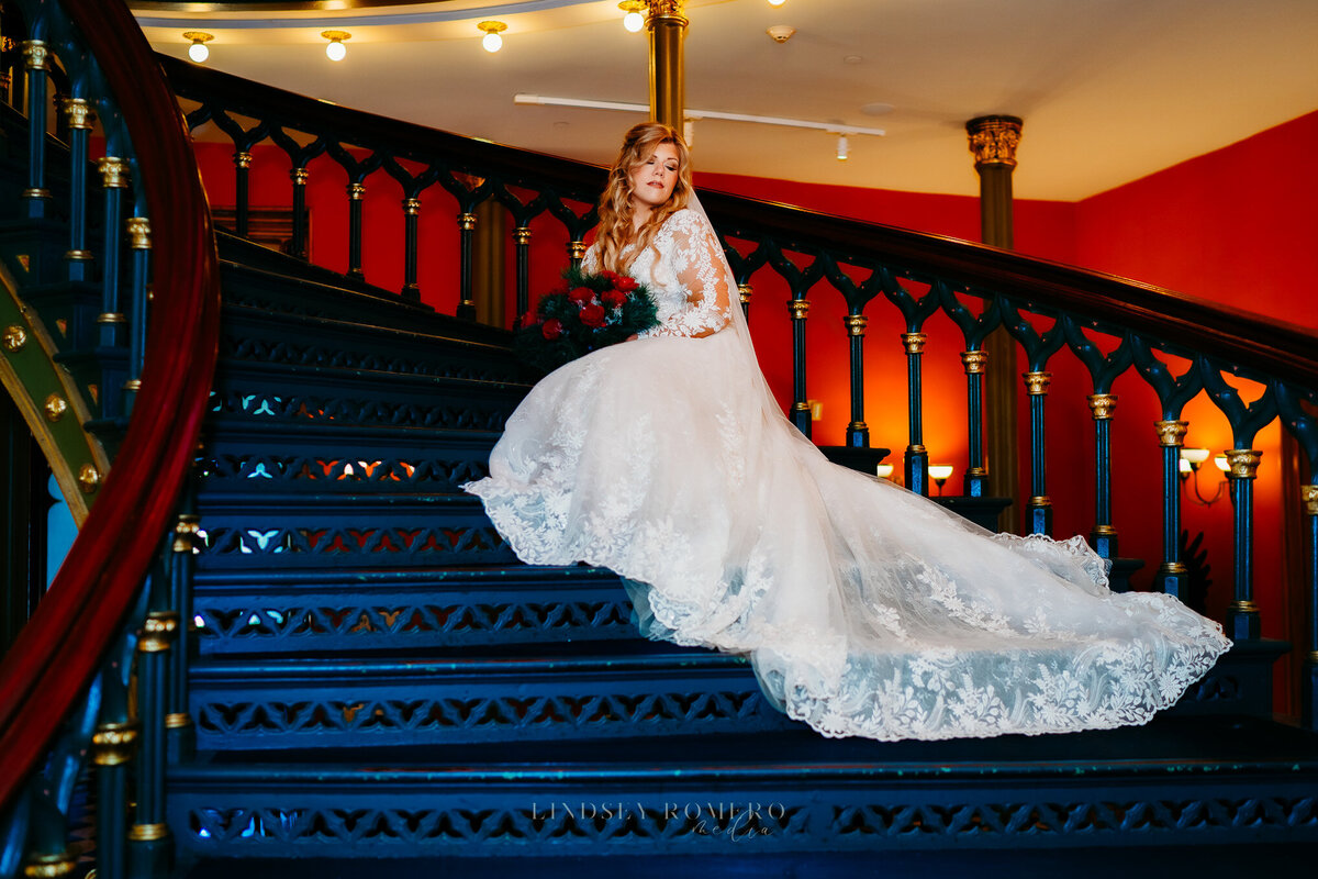 bridal pose with long veil on spiral staircase at old state capitol in baton rouge, la