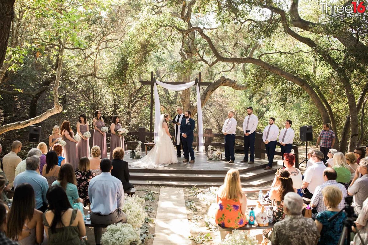 Bride and Groom taking their vows at the altar during an Oak Canyon Nature Center wedding ceremony